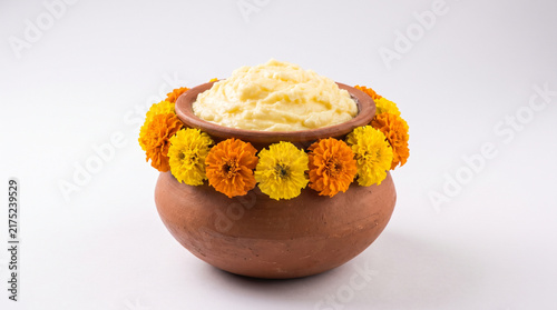 Clay Pot Filled With Fresh Butter Decorated With Marigold Flowers