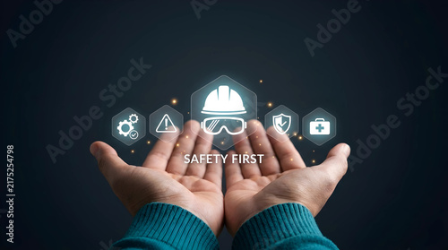 Industrial safety first concept featuring hands cupping digital icons for workplace protection, accident prevention, and occupational health awareness.
