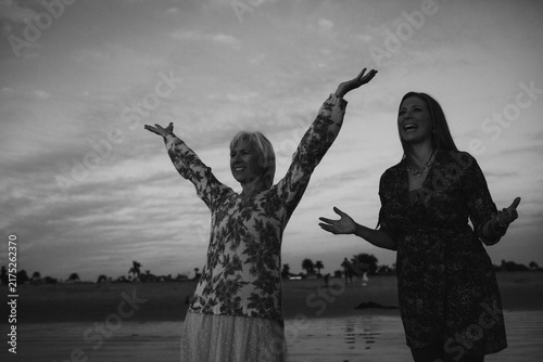 Mother and Daughter smiling at the beach