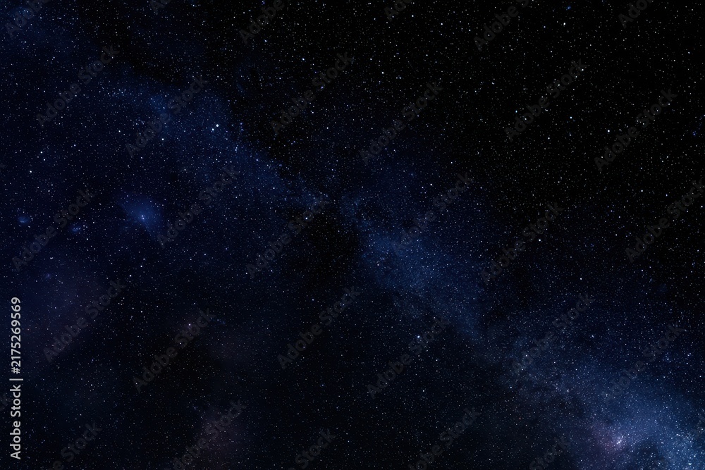 Fototapeta premium Cosmic night: expansive black space filled with twinkling stars and faint nebulae