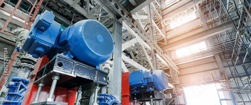 Canvastavla Industrial interior with blue electric motors and pumps amid steel beams for fac