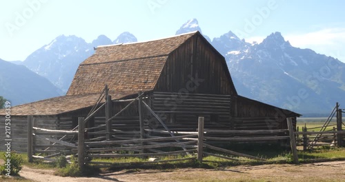 Historic wooden homesteads in a rural mountain landscape