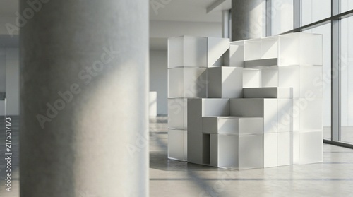 An abstract modular room divider made of white cubes stands in a bright, modern interior with large windows and concrete columns.