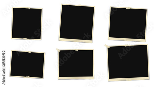 Set of six empty vintage polaroid frames with adhesive tape, arranged on a dark black background, for a nostalgic, display layout