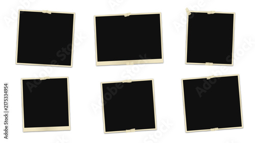 Six blank vintage polaroid frames with white borders and adhesive tape, arranged on a solid black background, for collage and display