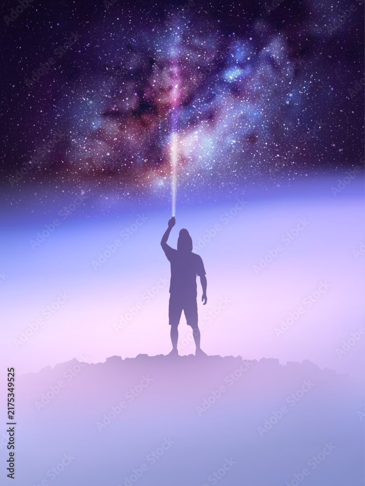 Obraz premium Man with flashlight on rocky mountain. Milky Way above foggy landscape