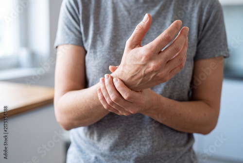 Close Up of Woman Holding Sore Wrist Suffering from Carpal Tunnel Syndrome