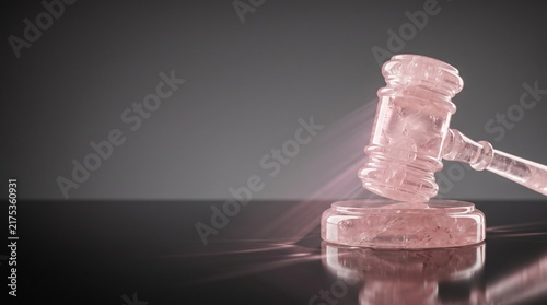 Translucent rose quartz judge gavel in pink crystal tones representing legal justice and authority against dark gradient background with copy space