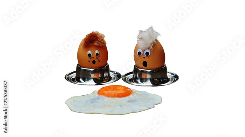 Konstfotografi Funny decorated boiled eggs in egg cups with googly eyes next to a fried egg cup