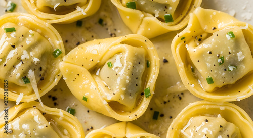 Close up view of fresh tortellini pasta with cheese and herbs culinary delight