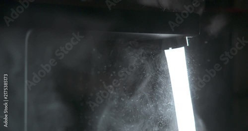 Faucet being turned off, water flow slowing to a stop, macro