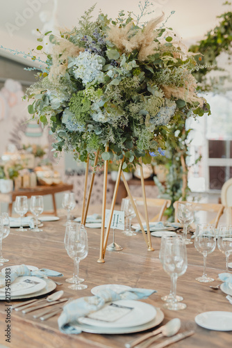 Quadro su tela Large lush floral arrangement with greenery decorating an elegant indoor celebration space