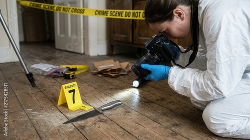 Crime Scene Investigation Photographer Documents Knife Evidence At Location