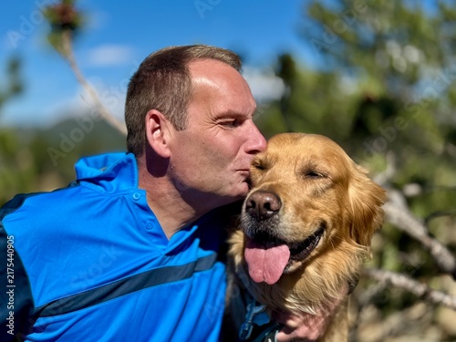 Man kissing his dog
