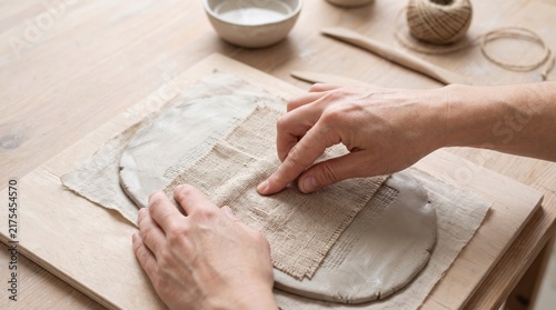 Fototapeta Hands working with clay pottery