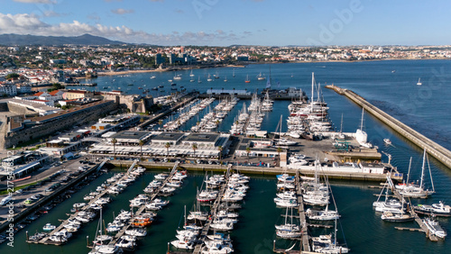 Fotografía Aerial panorama of Cascais marina with densely packed yachts, historic fortress