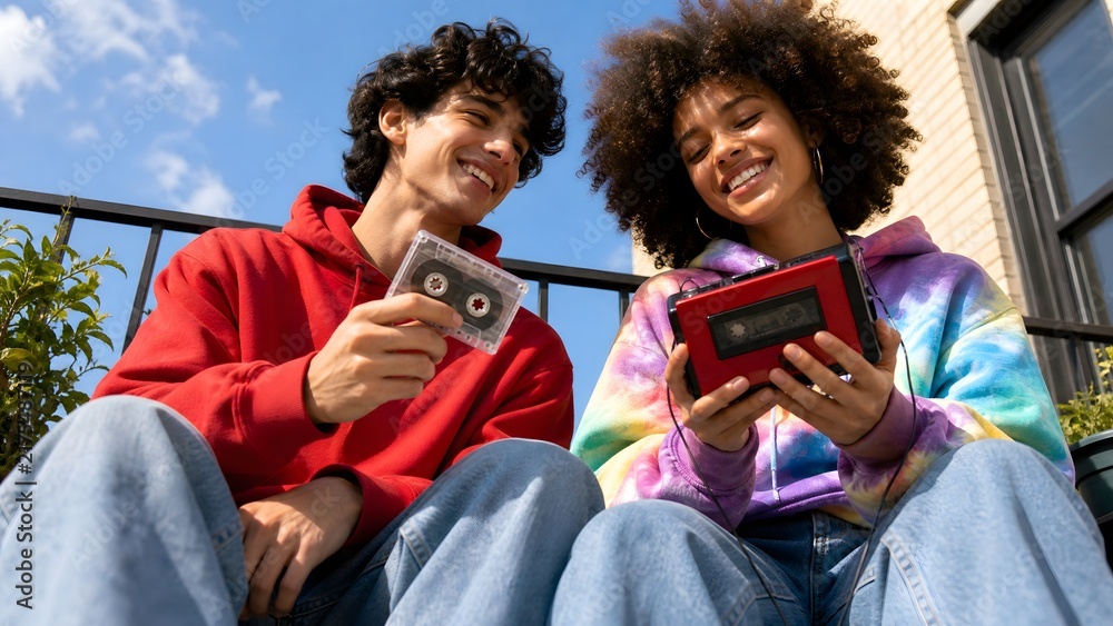 Obraz premium Friends Listening to Cassette Tape Player Outdoors