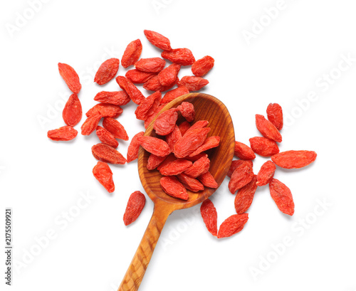 фотографія Wooden spoon with red dried goji berries on white background