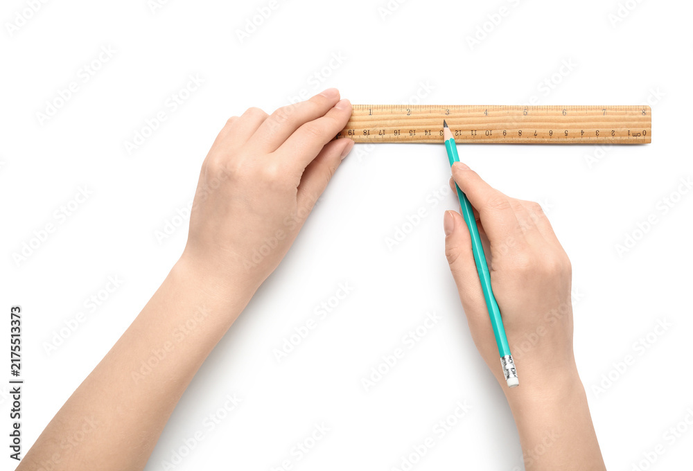 Naklejka premium Female hands with ruler and pencil on white background