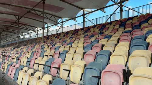 Colorful Empty Stadium Seats Under Covered Grandstand

