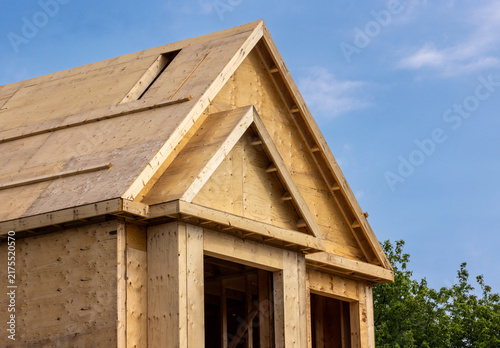 A plywood sheathed residential construction gable and roof with a skylight hole cut out