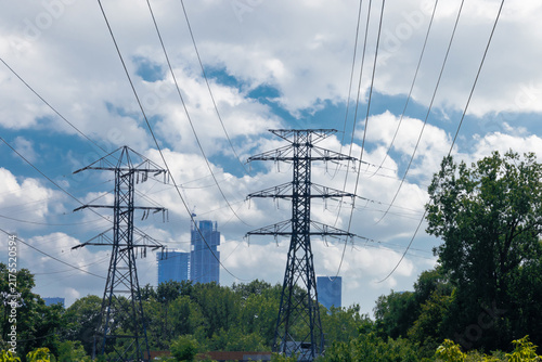 Konstfotografi High voltage Hydro electric towers with high rise constriction in the distance