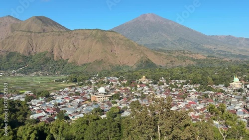 Volcanic Mountain Overlooking a Dense Mountain Town

