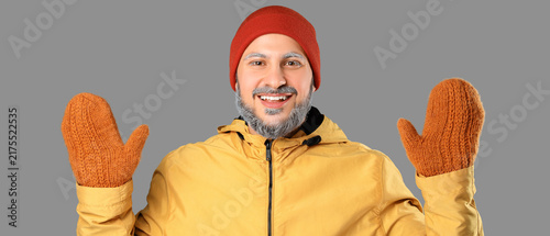 Fotografie Winter fashion and seasonal joy, happy man wearing warm beanie and knitted mitte