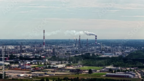 Aerial view of the Orlen Plock Production Plant with industrial smokestacks and steam in Plock, Mazowieckie, Poland.