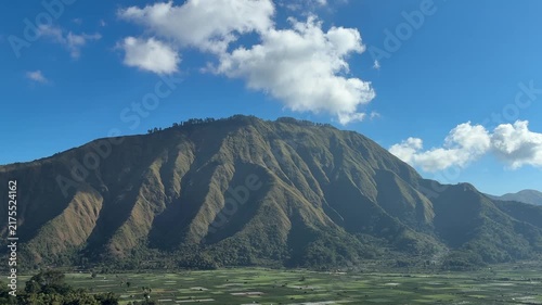 Dramatic Green Mountain Ridge Under a Blue Sky


