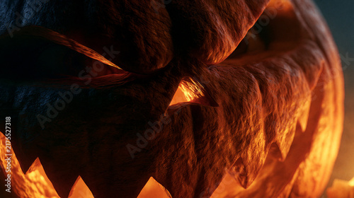 Close-up of a glowing carved Halloween pumpkin jack-o'-lantern with a spooky face.