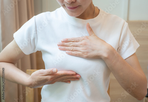 Canvastavla Cropped shot view of young Asian woman touching her breast for checking breast size or cancer awareness