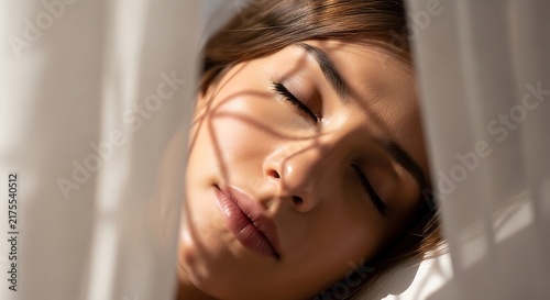 Serene moment of a sleeping woman behind the curtain in natural light