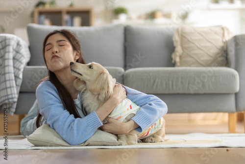 Cuadro en lienzo woman cuddling her cute dog at home, showing affection, companionship and a loving human pet bond