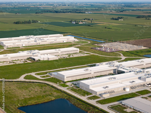 Aerial view of huge data center facility with rooftop cooling units and surrounding industrial infrastructure in DeKalb, Illinois