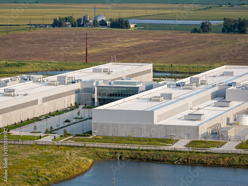 Aerial view of huge data center facility with rooftop cooling units and surrounding industrial infrastructure in DeKalb, Illinois