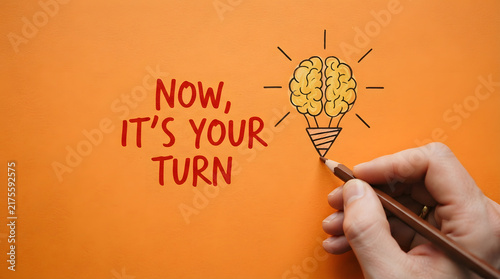 Person drawing brain inside lightbulb on bright background