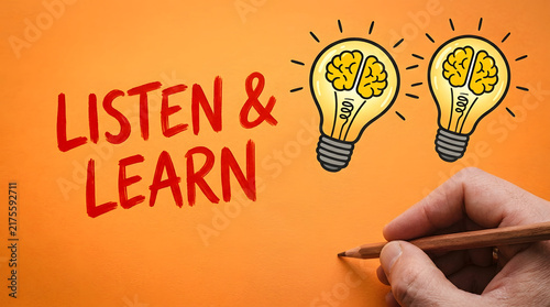 Hand writing listen and learn with brain lightbulbs on orange