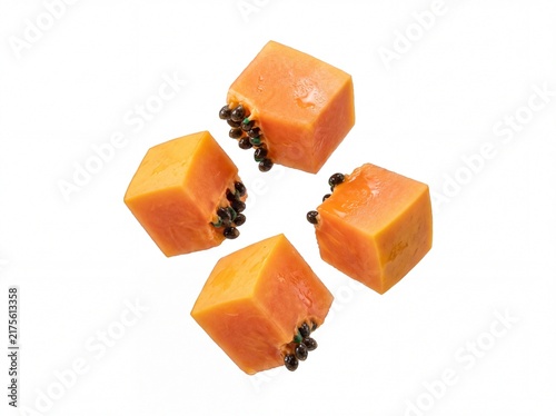 Fresh papaya cubes with seeds isolated on white background