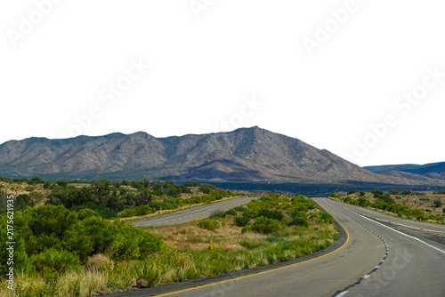 Empty desert highway curving through the arid landscape toward mountains in Arizona, USA.