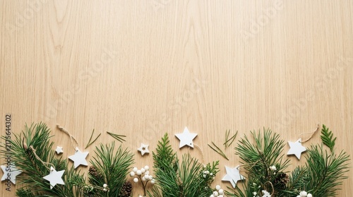 Stars and pine leaves on the wooden beige background copy space 