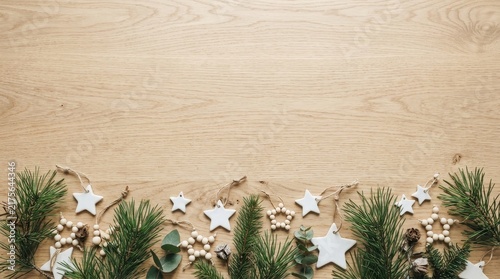 Stars and pine leaves on the wooden beige background copy space 
