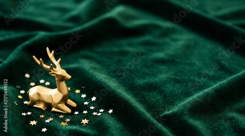Golden deer ornament for Christmas on the silky green fabric copy space 