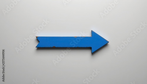 Blue arrow pointing right on a white background with slight texture and shadow.