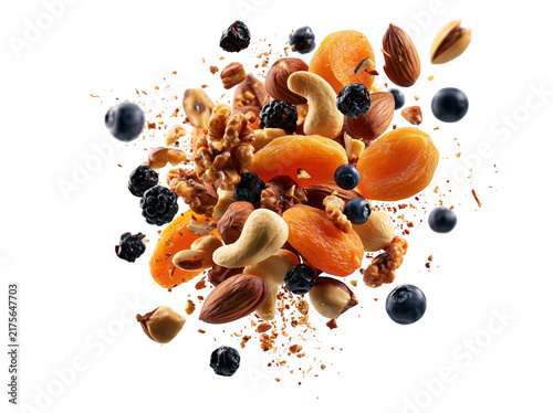 Explosion of mixed nuts and dried fruits isolated on white background