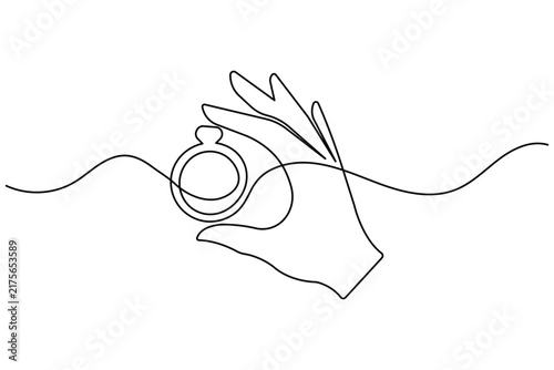 Ring line art showing a hand holding a ring with continuous line drawing and editable stroke vector graphic.