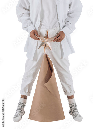 Фотография man with craft Christmas tree with star, in festive socks and white casual clothing on isolated transparent background