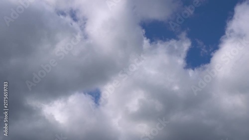 Time lapse blue sky with running clouds background. Timelapse of white clouds with blue sky. Moving cloudscape. Texture of clouds.