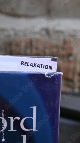 Relaxation Word on White Paper Representing Calmness Balance and Wellbeing