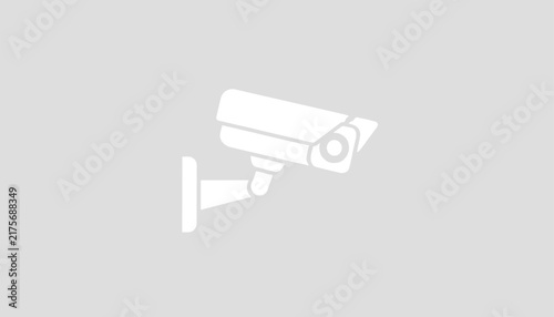 White security camera icon mounted on a wall shown in flat minimalist style over a solid light gray background.
